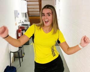 Female player outside squash court at Biddenden Squash Club, ready for junior competition.