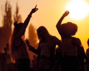 Stock image of people dancing outdoors in a park – used to represent Biddenden Squash Club’s summer BBQ party.